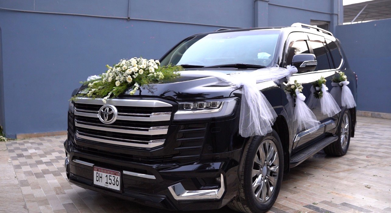 Black luxury SUV decorated for bride and groom departure - Wedding car rental Karachi
