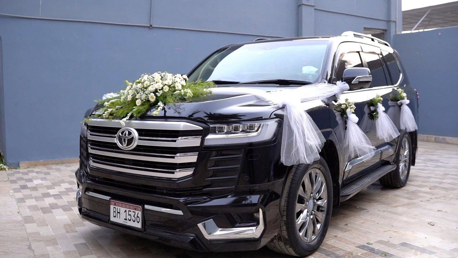 Floral decorated white Land Cruiser V8 wedding car provided by rent Land Cruiser Karachi service